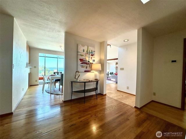 714 SW 296th St, Federal Way, WA 98023 - corridor featuring a textured ceiling, wood finished floors, and baseboards