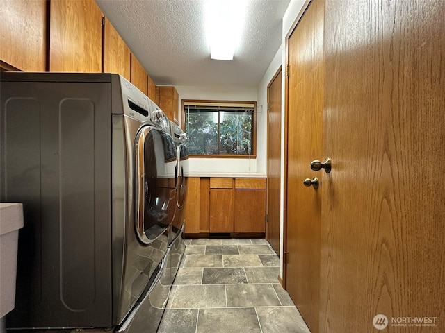 714 SW 296th St, Federal Way, WA 98023 - laundry room featuring cabinet space, stone finish flooring, and a textured ceiling