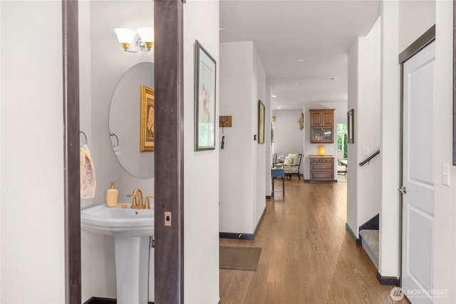 431 Timberland Loop, Mount Vernon, WA 98273 - hallway with light wood-style flooring, baseboards, and a sink
