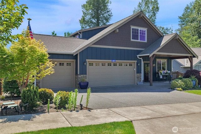 431 Timberland Loop, Mount Vernon, WA 98273 - view of front of home featuring stone siding, driveway, an attached garage, board and batten siding, and roof with shingles