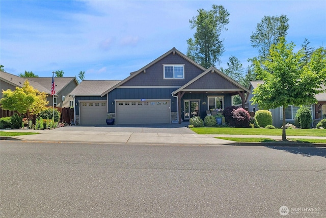 431 Timberland Loop, Mount Vernon, WA 98273 - view of front of home featuring board and batten siding, driveway, a garage, a front lawn, and stone siding