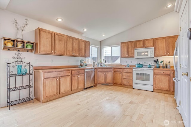 1649 Denise Cir, Wenatchee, WA 98801 - kitchen featuring white appliances, vaulted ceiling, a sink, light wood-style floors, and brown cabinetry