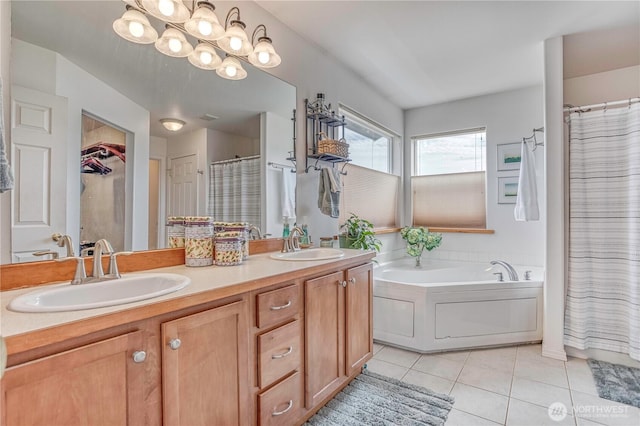 1649 Denise Cir, Wenatchee, WA 98801 - bathroom featuring tile patterned flooring, double vanity, a garden tub, a shower with curtain, and a walk in closet