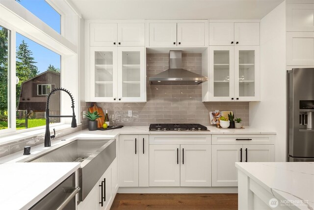 19722 Filbert Dr Unit B-3, Bothell, WA 98012 - kitchen with appliances with stainless steel finishes, wall chimney exhaust hood, healthy amount of natural light, and decorative backsplash