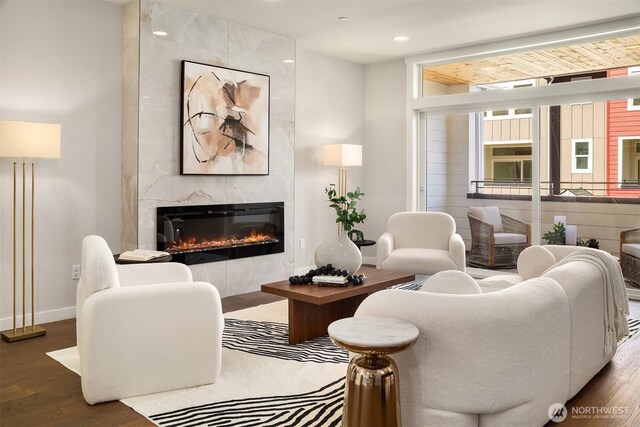 19722 Filbert Dr Unit B-3, Bothell, WA 98012 - living area featuring a tiled fireplace, wood finished floors, baseboards, and recessed lighting