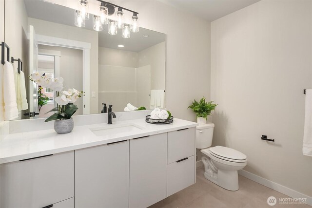 19722 Filbert Dr Unit B-3, Bothell, WA 98012 - bathroom featuring toilet, vanity, baseboards, tile patterned floors, and a shower