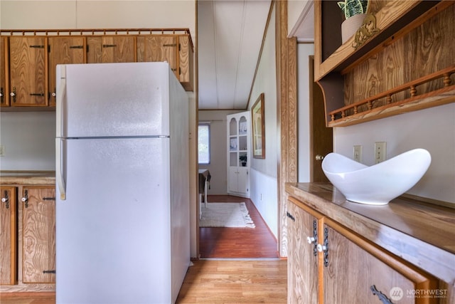 1851 Washington Dr, Point Roberts, WA 98281 - kitchen featuring freestanding refrigerator, light wood finished floors, brown cabinets, and light countertops