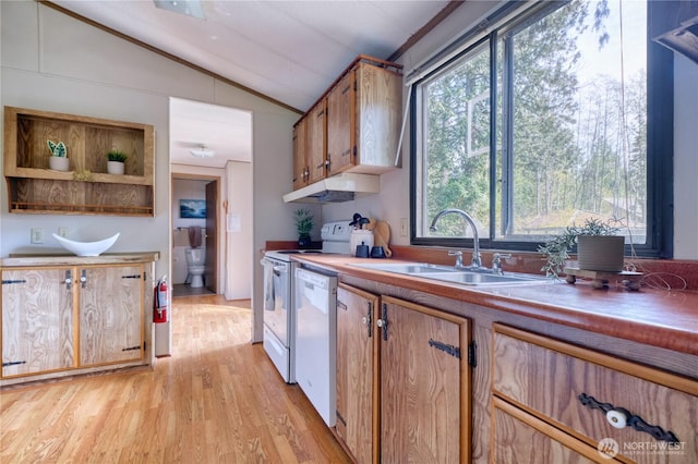 1851 Washington Dr, Point Roberts, WA 98281 - kitchen with white appliances, vaulted ceiling, a sink, light wood-style floors, and brown cabinetry