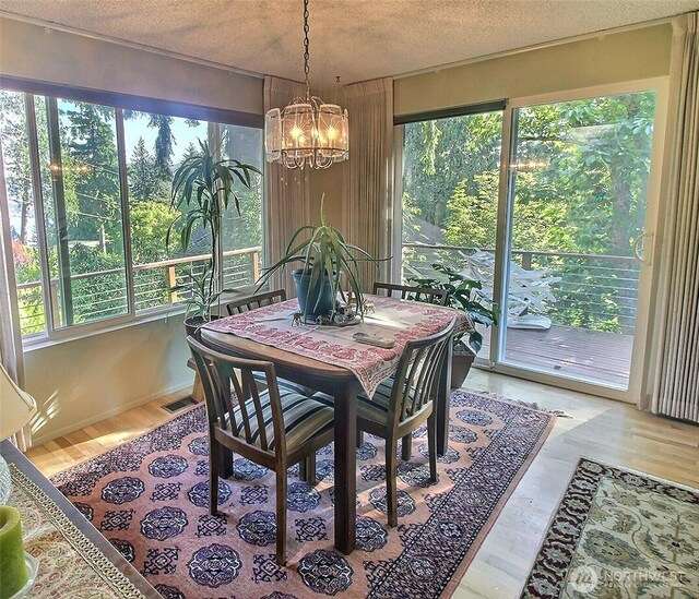 19640 SE 29th St, Sammamish, WA 98075 - dining area featuring a chandelier, wood finished floors, and a textured ceiling