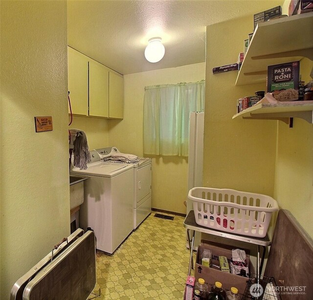 19640 SE 29th St, Sammamish, WA 98075 - laundry area featuring cabinet space, light floors, washing machine and clothes dryer, and a textured ceiling