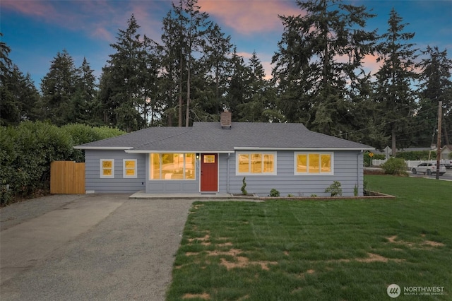 8206 N Way SW, Lakewood, WA 98498 - ranch-style home featuring a front lawn, driveway, a chimney, view of scattered trees, and roof with shingles