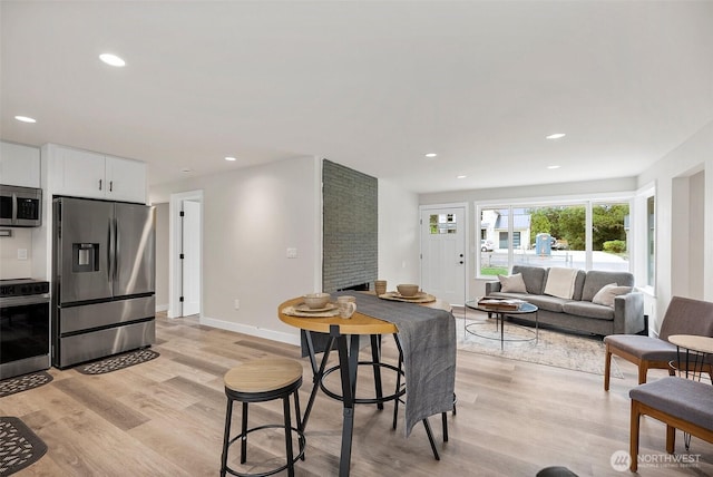 8206 N Way SW, Lakewood, WA 98498 - dining area featuring light wood-style floors, recessed lighting, and baseboards