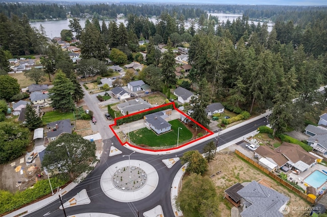 8206 N Way SW, Lakewood, WA 98498 - aerial view of residential area with a heavily wooded area, property boundaries highlighted, and a nearby body of water