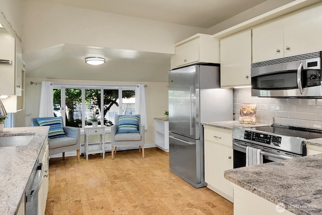 5521 34th Ave NE, Seattle, WA 98105 - kitchen with appliances with stainless steel finishes, backsplash, white cabinetry, and light stone counters