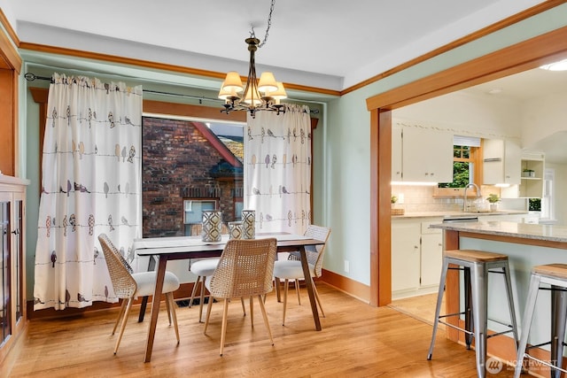 5521 34th Ave NE, Seattle, WA 98105 - dining area featuring a chandelier, light wood finished floors, and baseboards