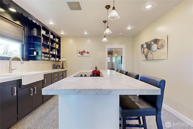 1250 Bryant, Walla Walla, WA 99362 - kitchen with a sink, a breakfast bar area, tasteful backsplash, a kitchen island, and recessed lighting