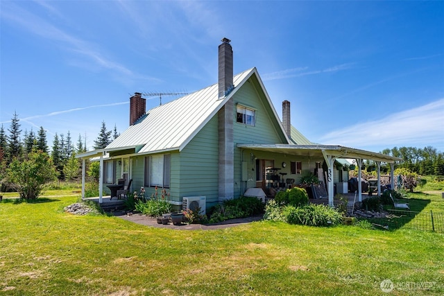 300 Brim Rd, Onalaska, WA 98570 - view of side of home featuring a chimney, a yard, a cooling unit, and metal roof