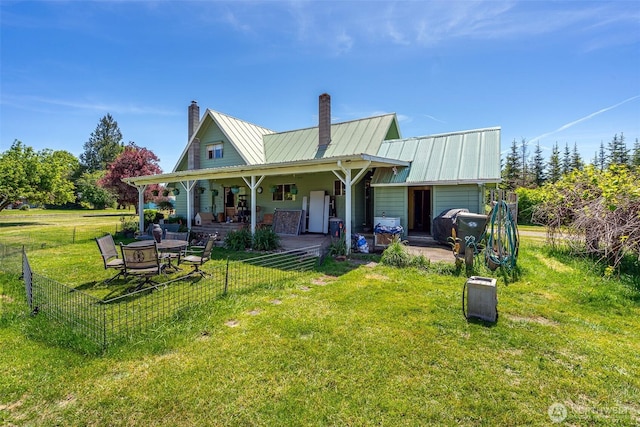 300 Brim Rd, Onalaska, WA 98570 - rear view of property with a chimney, metal roof, and a standing seam roof
