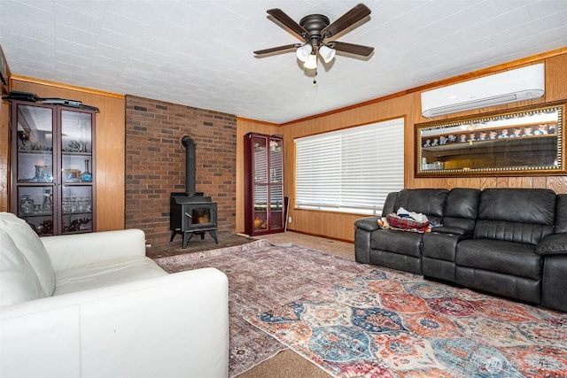 300 Brim Rd, Onalaska, WA 98570 - carpeted living room with an AC wall unit, wooden walls, a wood stove, and a ceiling fan