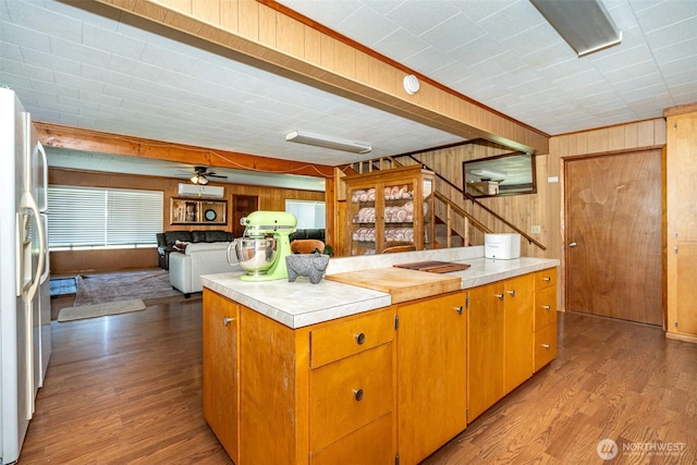 300 Brim Rd, Onalaska, WA 98570 - kitchen featuring white refrigerator with ice dispenser, wood finished floors, wood walls, and light countertops