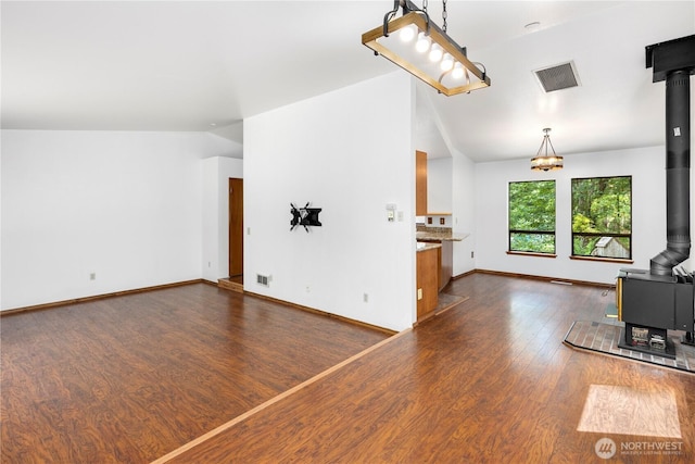 23611 Friar Creek Rd, Monroe, WA 98272 - unfurnished living room featuring a wood stove, dark wood-style flooring, and vaulted ceiling