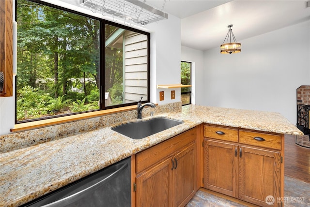 23611 Friar Creek Rd, Monroe, WA 98272 - kitchen with dishwasher, light stone counters, brown cabinetry, and a peninsula