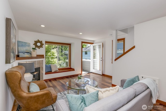 12046 33rd Ave NE Unit A, Seattle, WA 98125 - living room featuring wood finished floors, a tile fireplace, recessed lighting, and baseboards