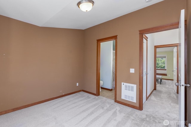 12046 33rd Ave NE Unit A, Seattle, WA 98125 - unfurnished bedroom featuring light carpet, baseboards, and ensuite bathroom