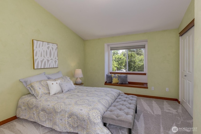 12046 33rd Ave NE Unit A, Seattle, WA 98125 - bedroom with carpet floors, baseboards, vaulted ceiling, and a closet
