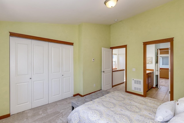 12046 33rd Ave NE Unit A, Seattle, WA 98125 - bedroom with a closet, carpet flooring, baseboards, and ensuite bathroom