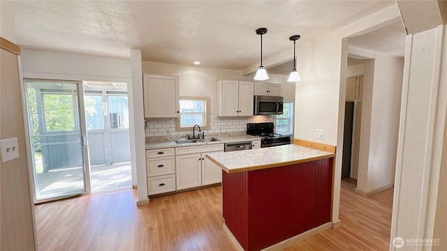 7459 Blaine Rd, Blaine, WA 98230 - kitchen with stainless steel appliances, a sink, decorative backsplash, and light wood-style floors