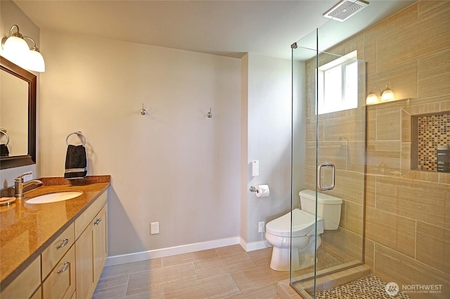 478 Eagle Crest Rd, Camano Island, WA 98282 - bathroom with toilet, a stall shower, vanity, and baseboards
