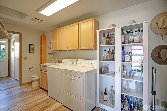 478 Eagle Crest Rd, Camano Island, WA 98282 - laundry room with separate washer and dryer, light wood-type flooring, a bar, and baseboards