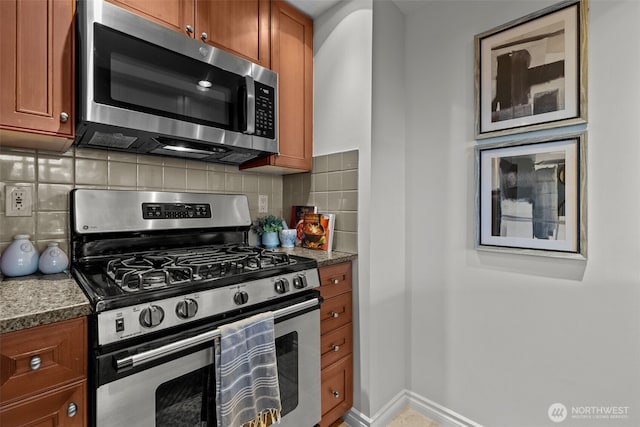 1420 Terry Ave Unit 1203, Seattle, WA 98101 - kitchen featuring appliances with stainless steel finishes, brown cabinetry, decorative backsplash, and dark stone counters