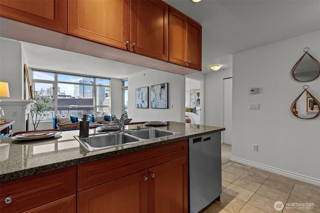 1420 Terry Ave Unit 1203, Seattle, WA 98101 - kitchen with stainless steel dishwasher, a sink, light tile patterned flooring, brown cabinetry, and baseboards