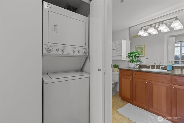 1420 Terry Ave Unit 1203, Seattle, WA 98101 - washroom featuring stacked washer / drying machine and light tile patterned floors
