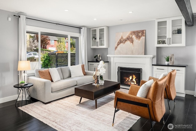 2815 31st Ave W, Seattle, WA 98199 - living area featuring a warm lit fireplace, dark wood-type flooring, baseboards, and recessed lighting