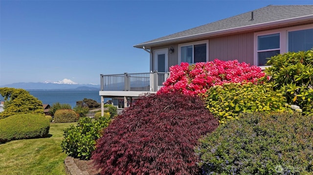 1042 Shorecrest Pl, Camano Island, WA 98282 - view of side of home with a balcony, a water and mountain view, roof with shingles, and a lawn