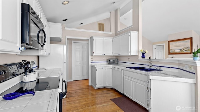 1042 Shorecrest Pl, Camano Island, WA 98282 - kitchen with black microwave, range with electric cooktop, dishwasher, tile countertops, and white cabinetry