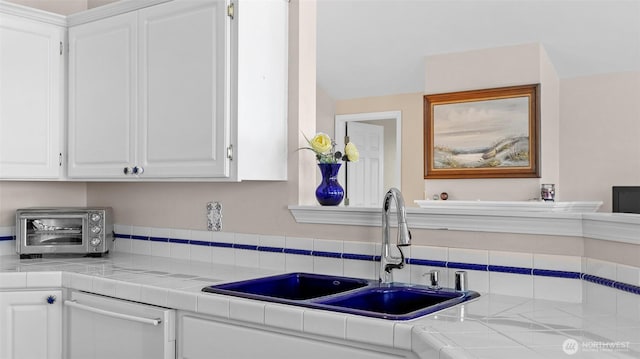 1042 Shorecrest Pl, Camano Island, WA 98282 - kitchen with dishwashing machine, white cabinets, and tile countertops