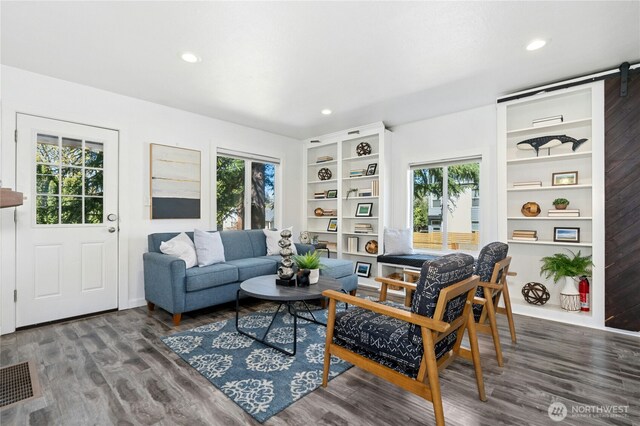 10056 Interlake Ave N, Seattle, WA 98133 - living room featuring plenty of natural light, wood finished floors, recessed lighting, built in features, and baseboards