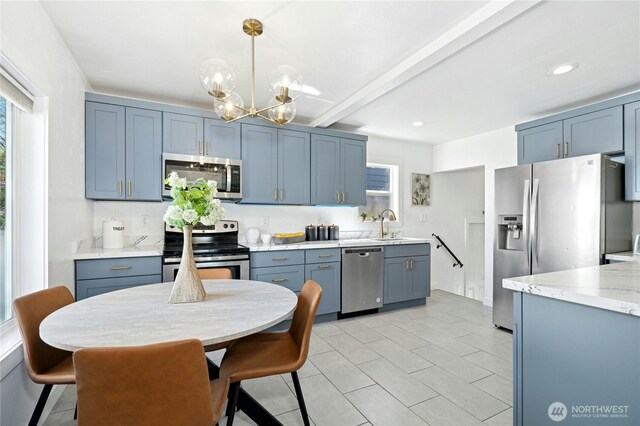 10056 Interlake Ave N, Seattle, WA 98133 - kitchen featuring appliances with stainless steel finishes, a chandelier, decorative light fixtures, beam ceiling, and light stone counters