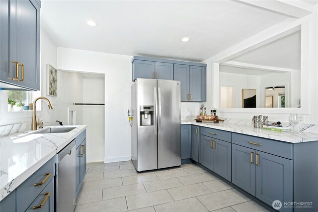 10056 Interlake Ave N, Seattle, WA 98133 - kitchen with stainless steel appliances, light stone countertops, a sink, light tile patterned floors, and recessed lighting