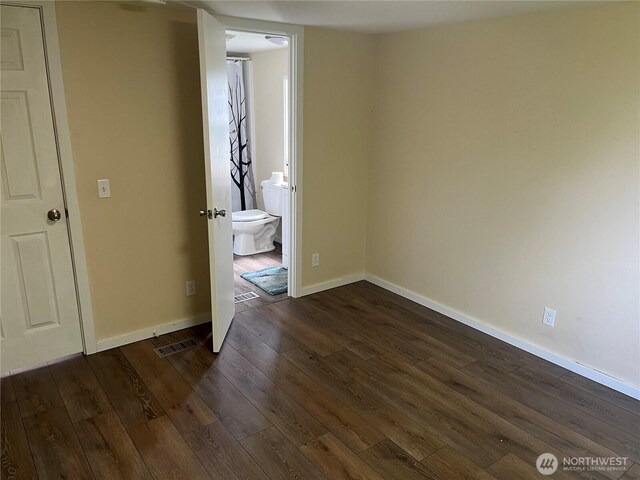 30 G St, Forks, WA 98331 - unfurnished room with dark wood-style flooring and baseboards
