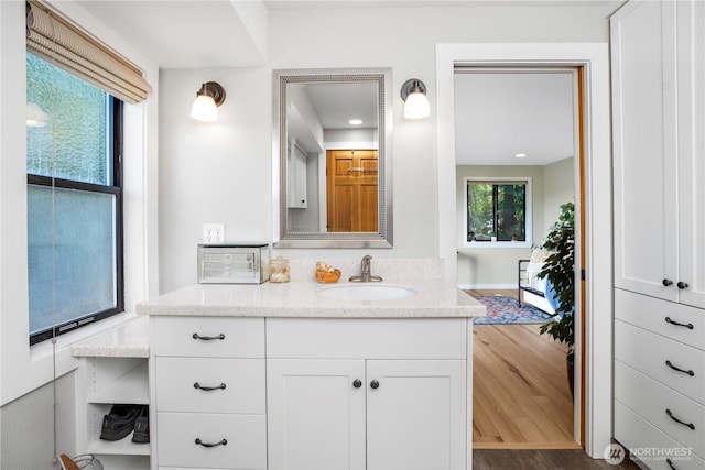 2715 Garfield Ave SE, Port Orchard, WA 98366 - bathroom featuring vanity, wood finished floors, and recessed lighting