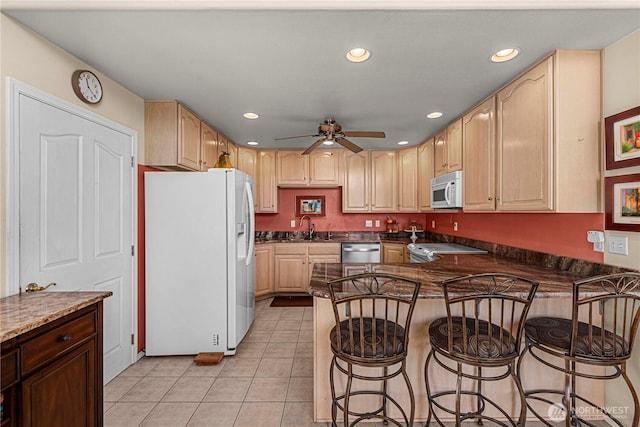 2509 Boston Ave NW, East Wenatchee, WA 98802 - kitchen featuring white appliances, a sink, a peninsula, light tile patterned floors, and a ceiling fan