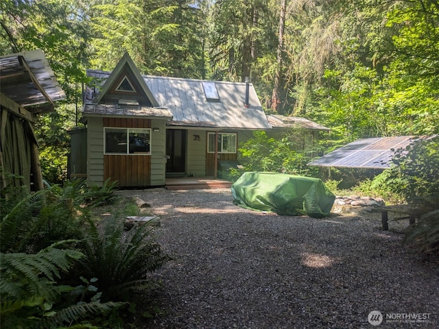63883 Cascade Park Pl Unit 1D71, Marblemount, WA 98267 - rear view of house featuring solar panels and a wooded view