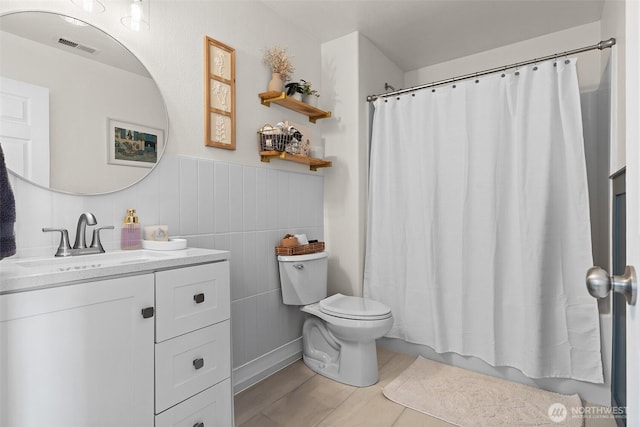 12524 SE 295th St, Auburn, WA 98092 - bathroom with vanity, toilet, and a wainscoted wall