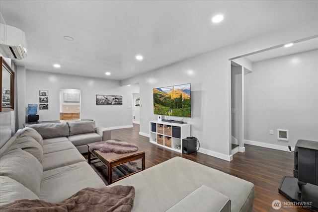 2722 112th St E, Tacoma, WA 98455 - living room featuring a wall mounted air conditioner, baseboards, recessed lighting, and dark wood-style flooring