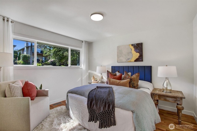 9030 6th Ave NW, Seattle, WA 98117 - bedroom with baseboards and wood finished floors